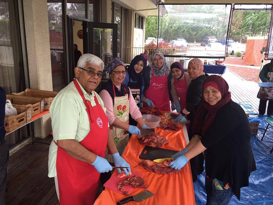 Hashim Abdul Rahman OAM serving at a community BBQ