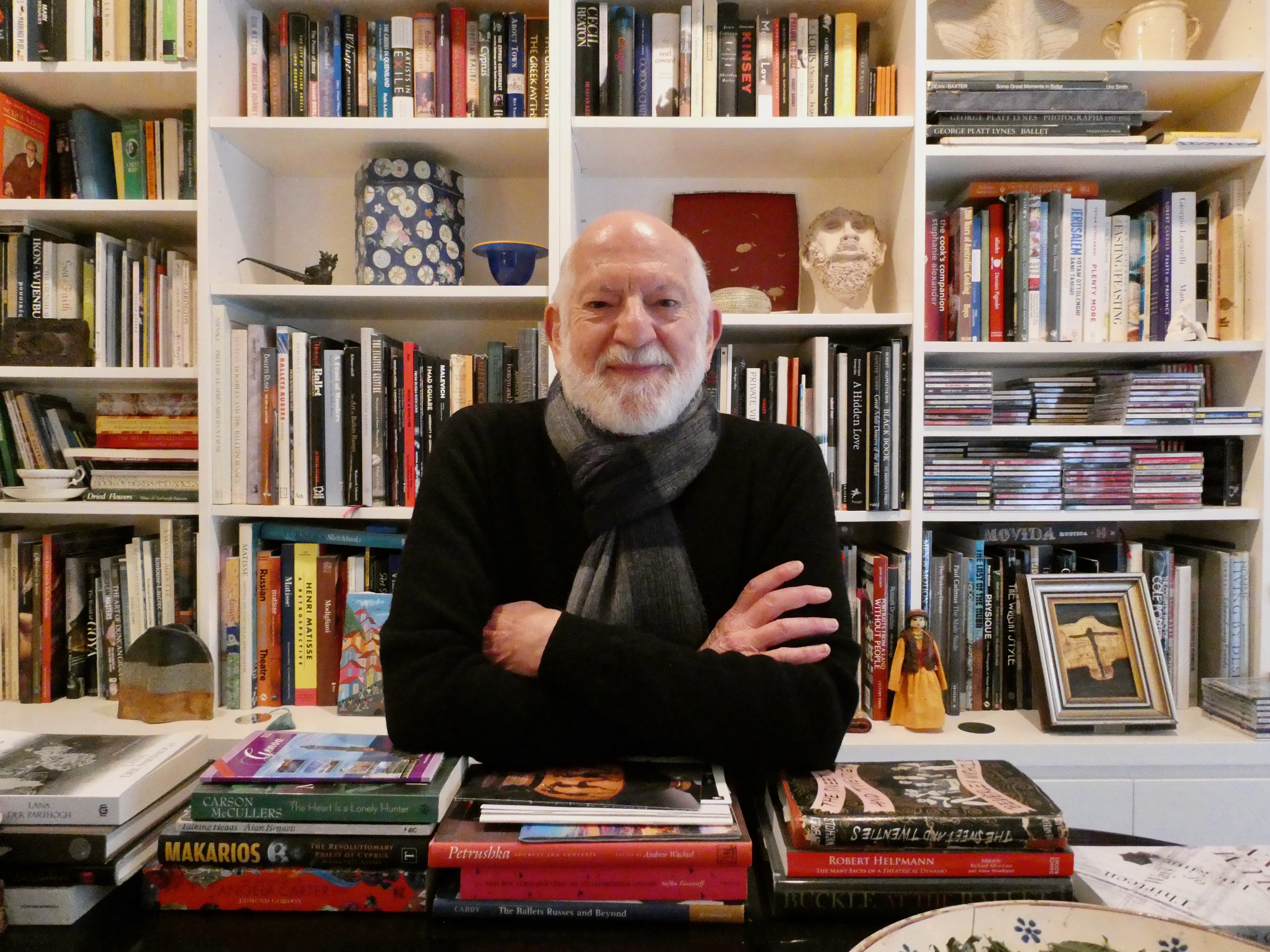 Mr Lee Christofis AM sitting in his office (photo is courtesy of Dance Australia)