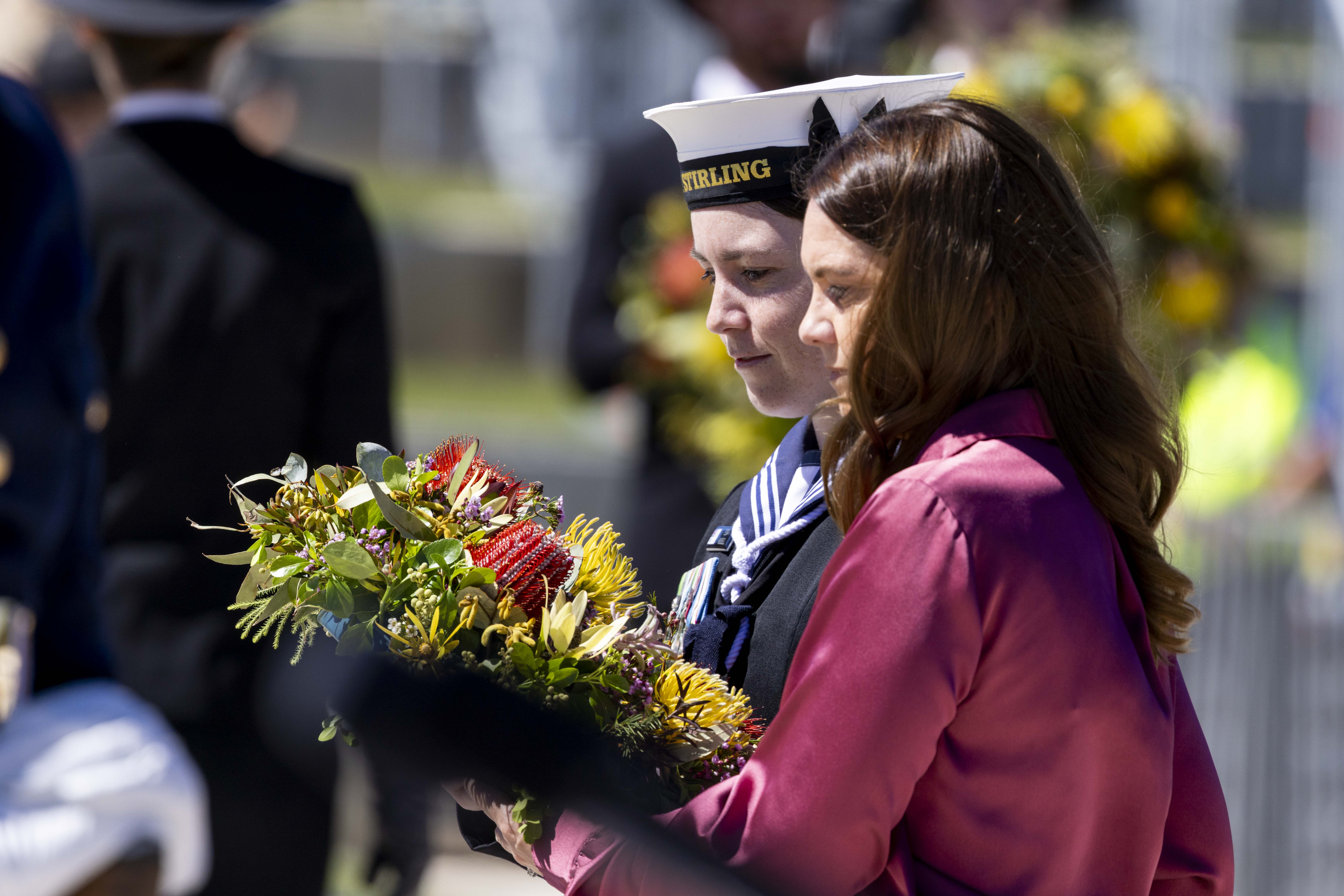 Family members laying wreath. 