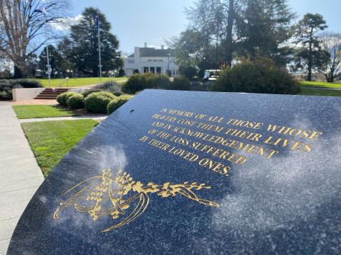 A dark marble plinth with the words 'in memory of all those whose bravery cost them their lives and in acknowledgement of the loss suffered by their loved ones'