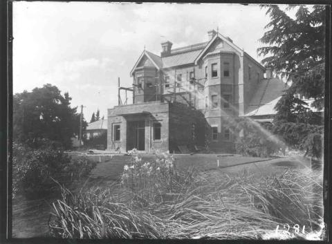 a black and white photo of a three story building