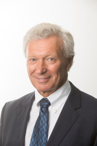 Headshot of Dr Russell Scrimshaw smiling at camera