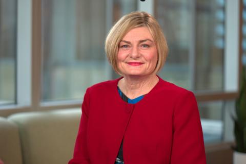 Jane Spring, headshot, smiling at camera