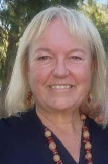 Caroline Hughes AM smiling at camera
